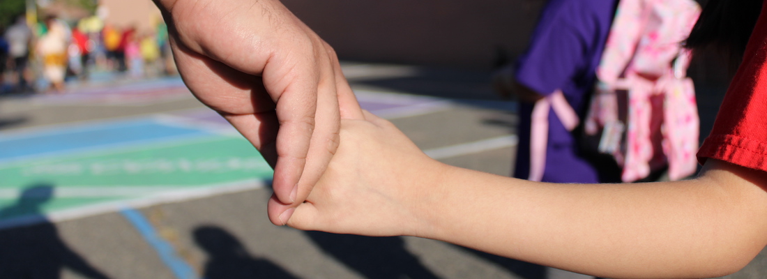 Student holding parent's hand